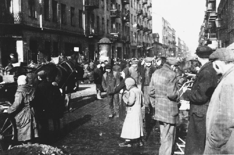 Jews move along a crowded street in the Warsaw ghetto